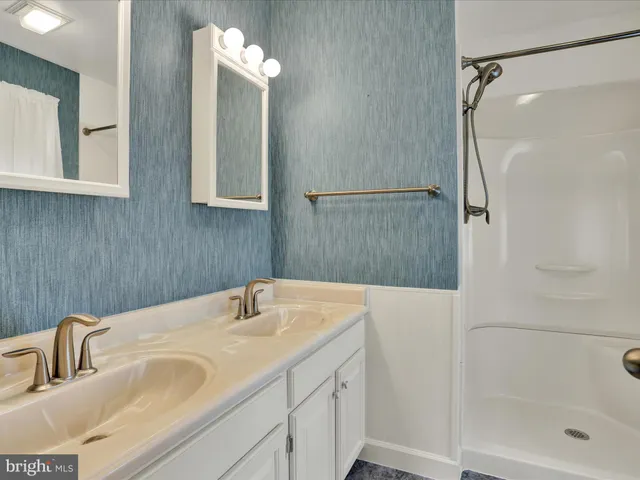 a bathroom with a sink and mirror