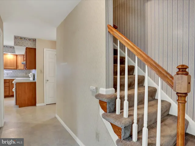 a view of staircase with wooden floor and windows