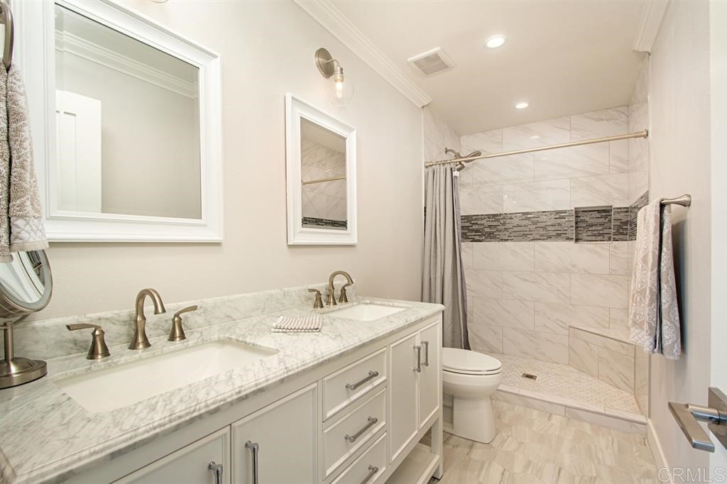3701 Catalina Drive Carlsbad, CA 92010 - Photo 21 of 25 a bathroom with a granite countertop sink toilet and shower
