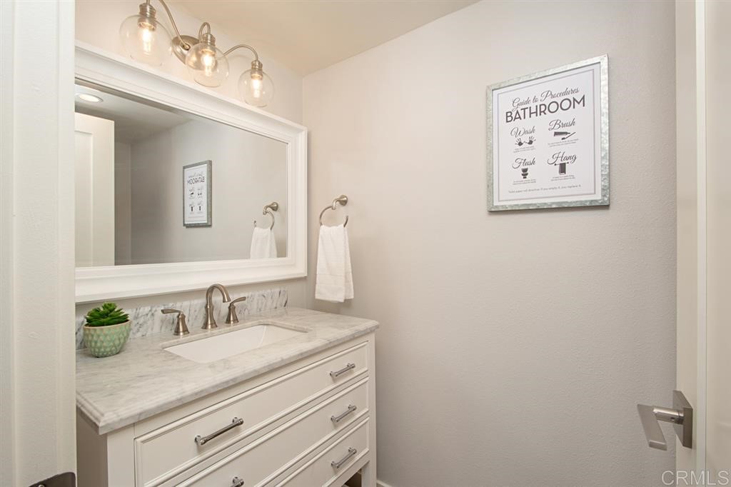 3701 Catalina Drive Carlsbad, CA 92010 - Photo 8 of 25 a bathroom with a granite countertop sink vanity and mirror