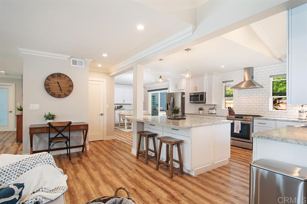 3701 Catalina Drive Carlsbad, CA 92010 - Photo 9 of 25 a large kitchen with a table and chairs