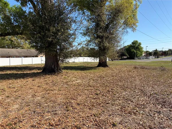 a view of a field of grass and trees