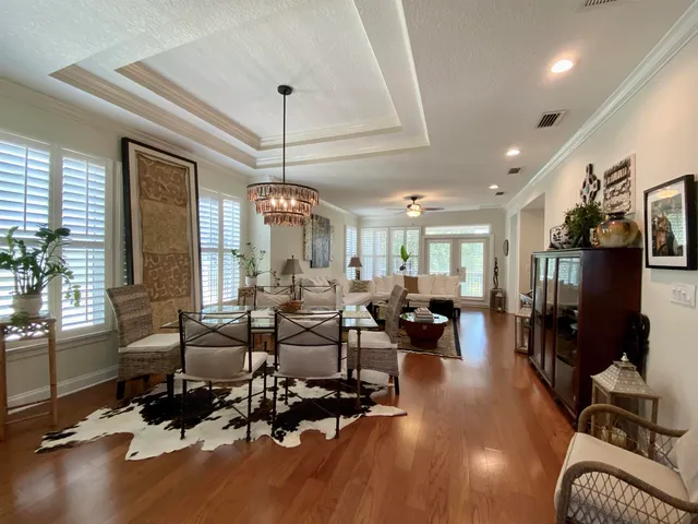 a living room with lots of furniture and a chandelier