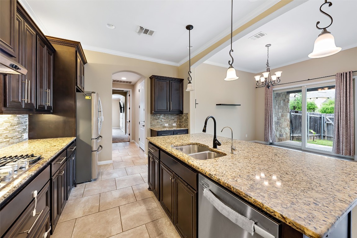 2000 Manada Trail Leander, TX 78641 - Photo 15 of 36 A well-appointed kitchen showcasing granite countertops and convenient outdoor access.