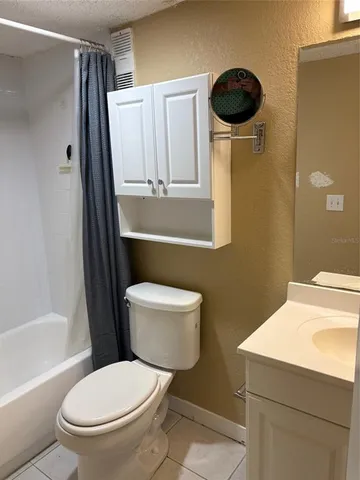 a bathroom with a toilet a sink and a shower