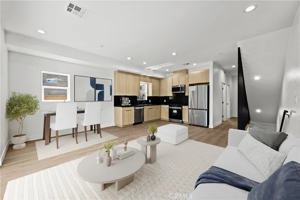 a living room with furniture kitchen and a table