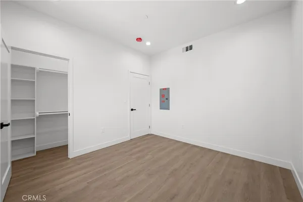 a bathroom with a granite countertop sink a toilet a mirror and shower