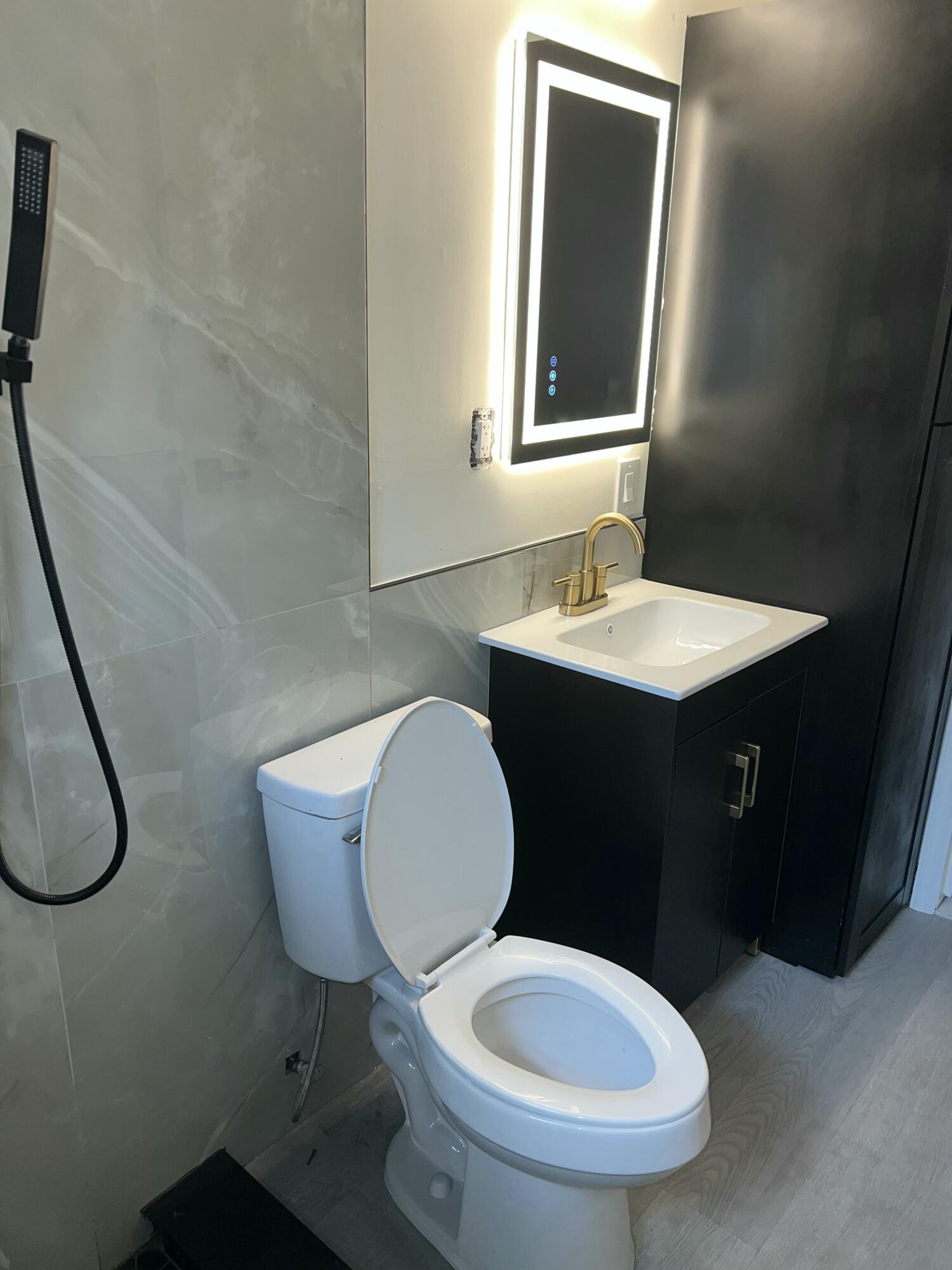 1016 Chipola Road, Unit B Fort Pierce, FL 34950 - Photo 11 of 17 a bathroom with a toilet sink and mirror