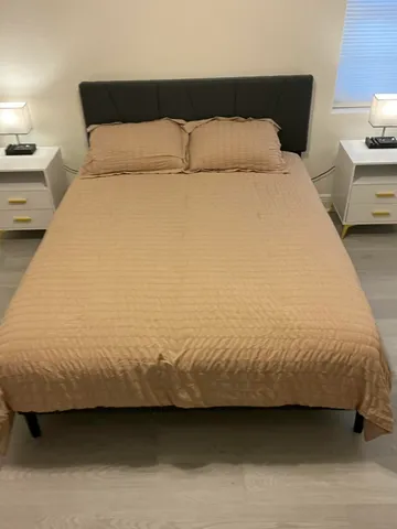 a bedroom with a bed and lamp