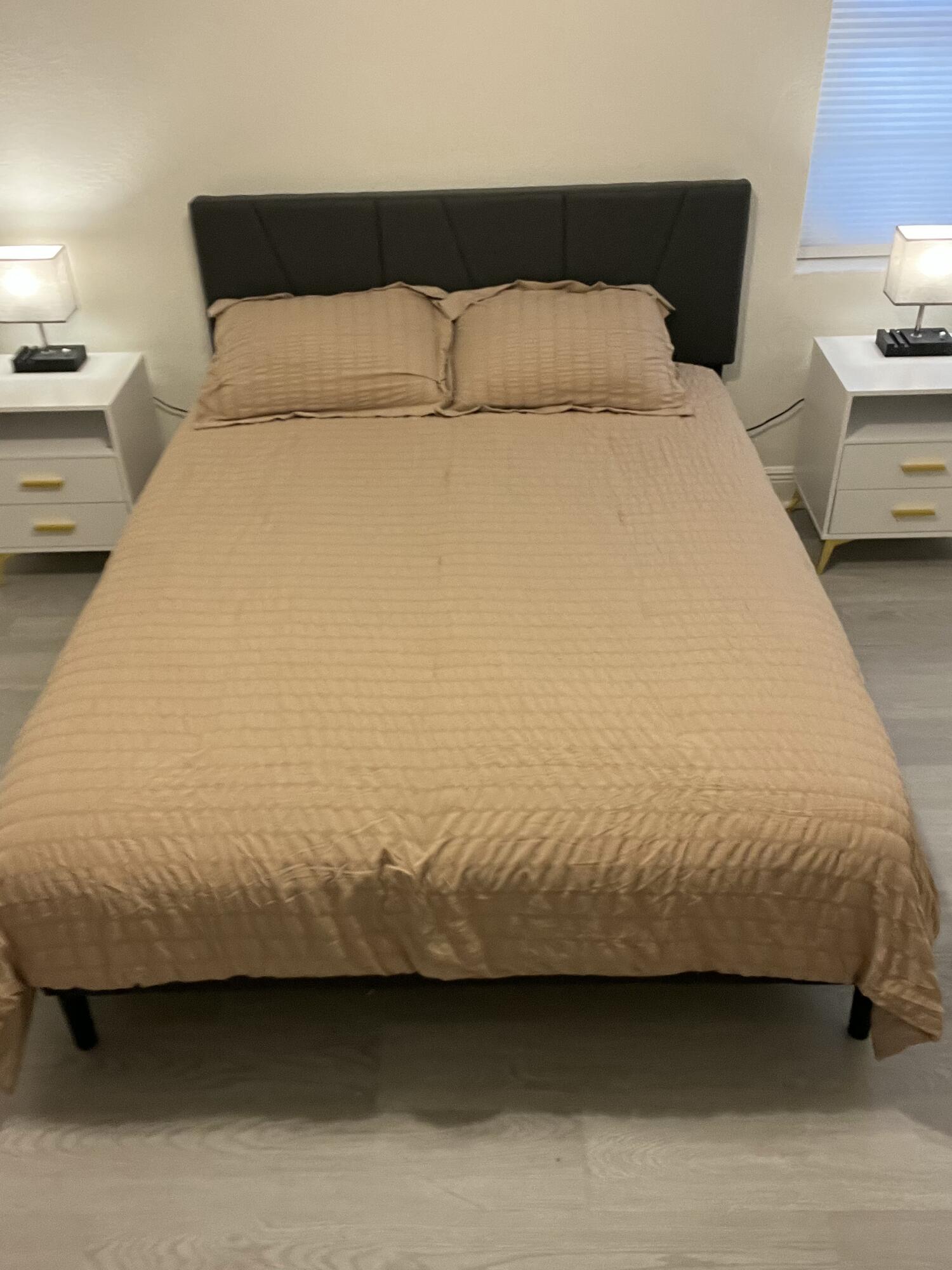 1016 Chipola Road, Unit B Fort Pierce, FL 34950 - Photo 14 of 17 a bedroom with a bed and lamp