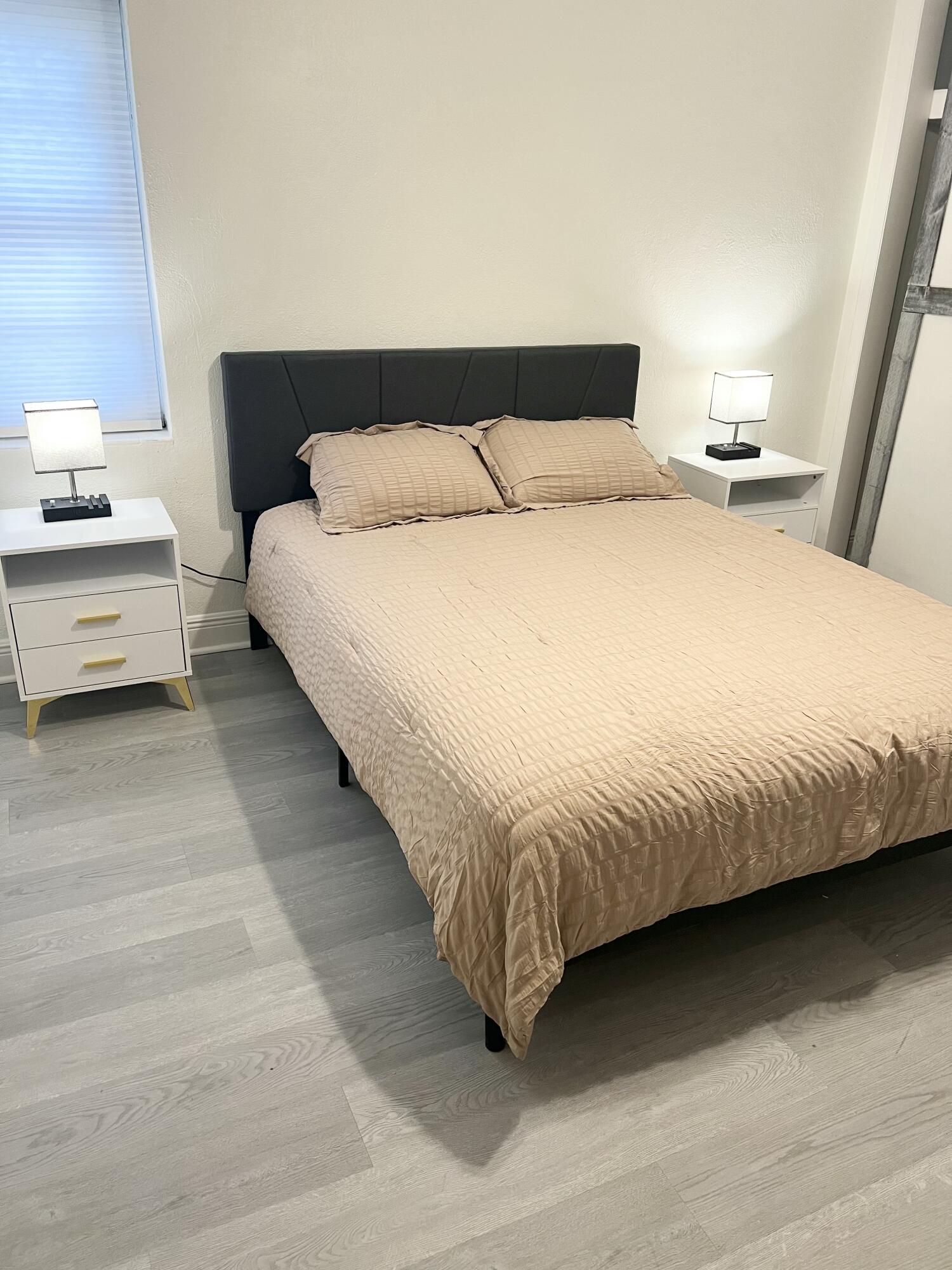 1016 Chipola Road, Unit B Fort Pierce, FL 34950 - Photo 16 of 17 a bedroom with a bed and a night stand