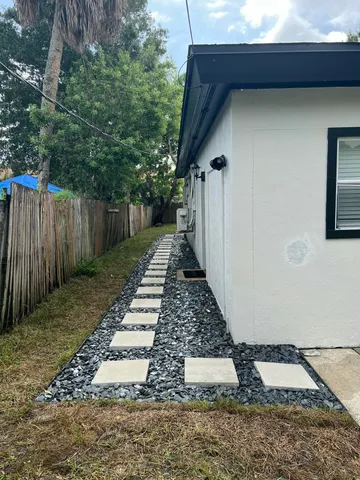 a view of a backyard with pathway