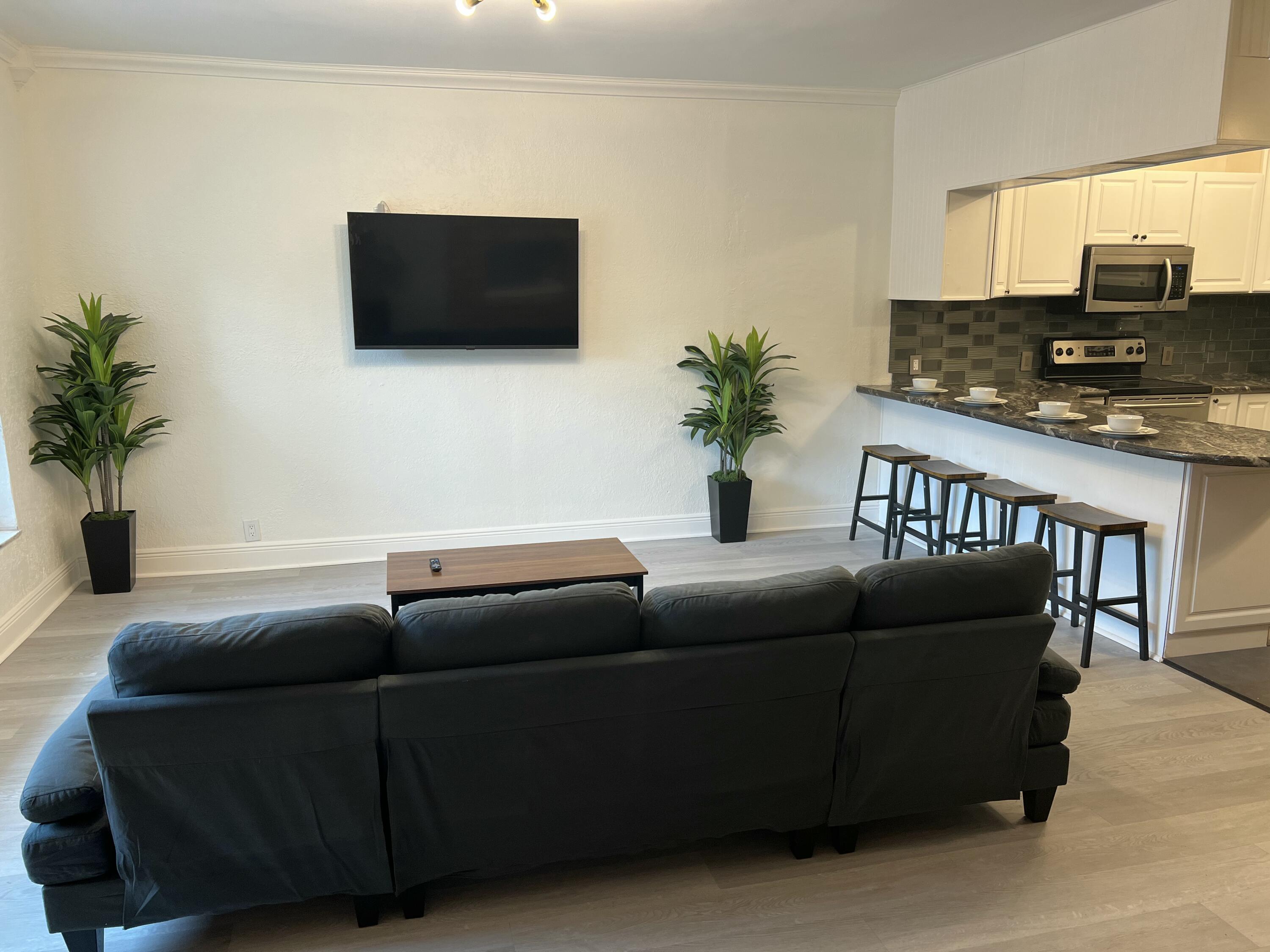 1016 Chipola Road, Unit B Fort Pierce, FL 34950 - Photo 4 of 17 a living room with furniture and a flat screen tv