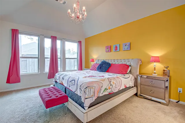 a bedroom with a bed and a chandelier