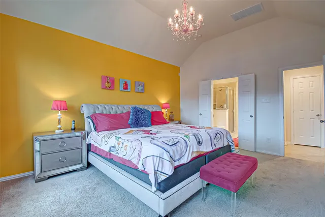 a bedroom with bed and a chandelier