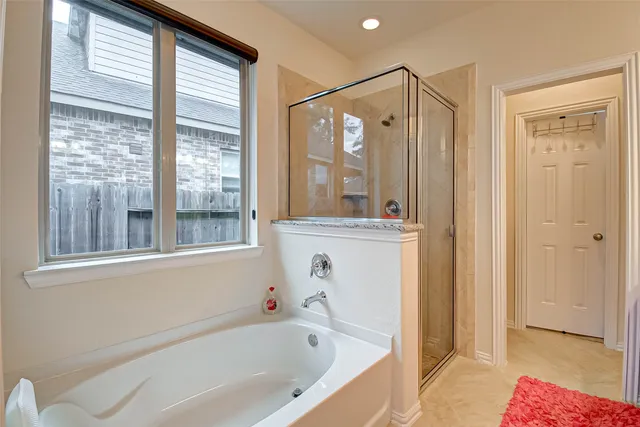 a bathroom with a bathtub and a shower