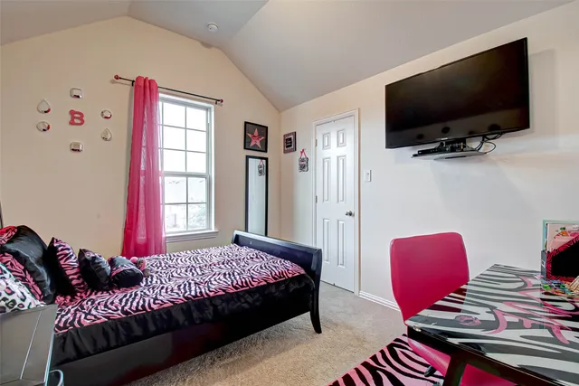 a bedroom with a bed and flat screen tv