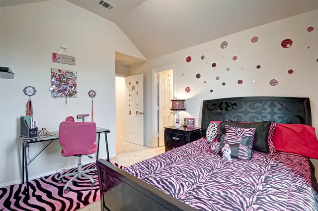 a bedroom with a bed and a chair in it