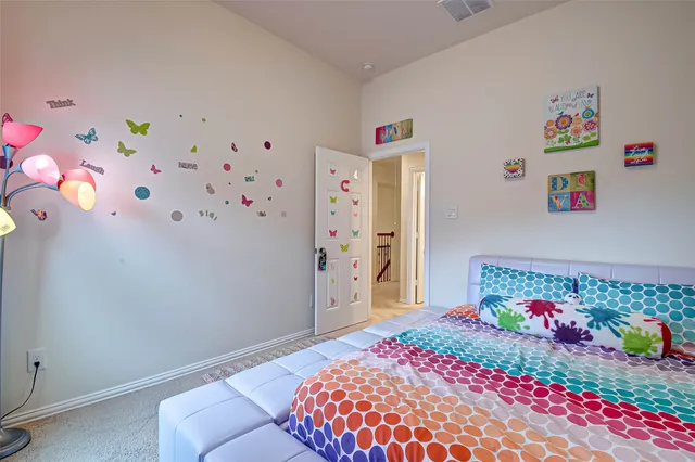 a bedroom with a bed and a dresser