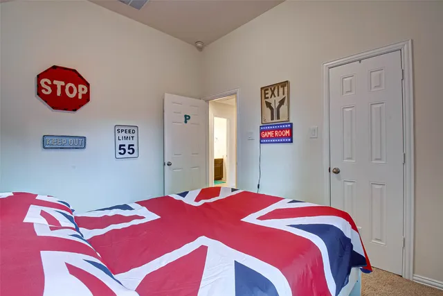 a bedroom with a bed and a chandelier