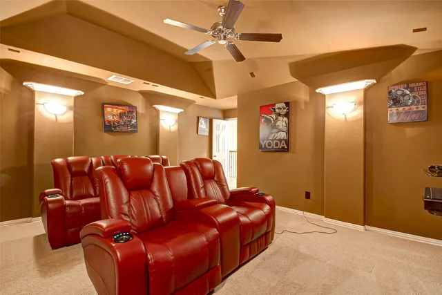 a media room with lots of chairs and a projector