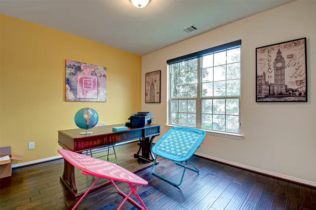 a reading room with furniture and wooden floor