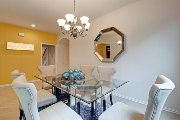 a dining room with furniture and chandelier