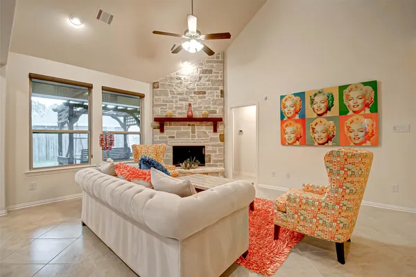 a living room with furniture and a fireplace