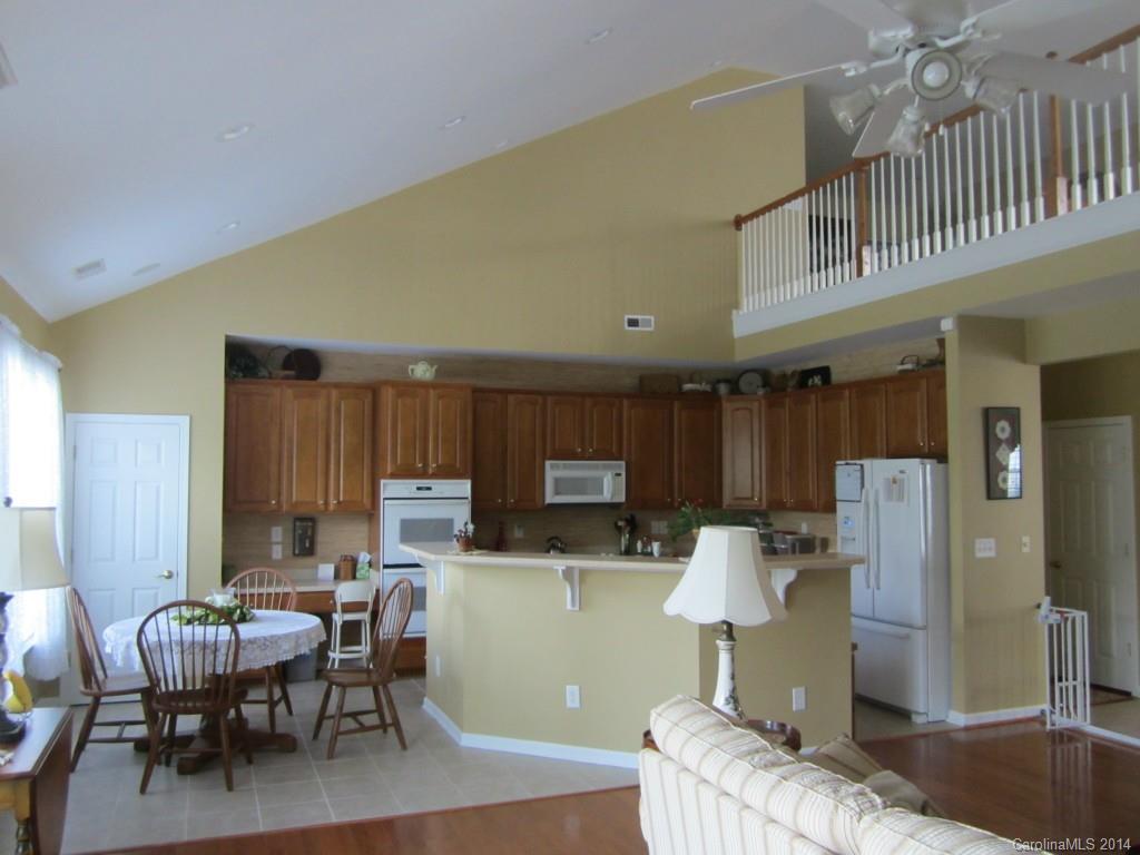 547 Turquoise Way Fort Mill, SC 29708 - Photo 5 of 12 a kitchen with a table chairs refrigerator and cabinets