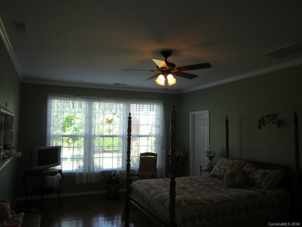 547 Turquoise Way Fort Mill, SC 29708 - Photo 7 of 12 a bedroom with a bed and a chandelier