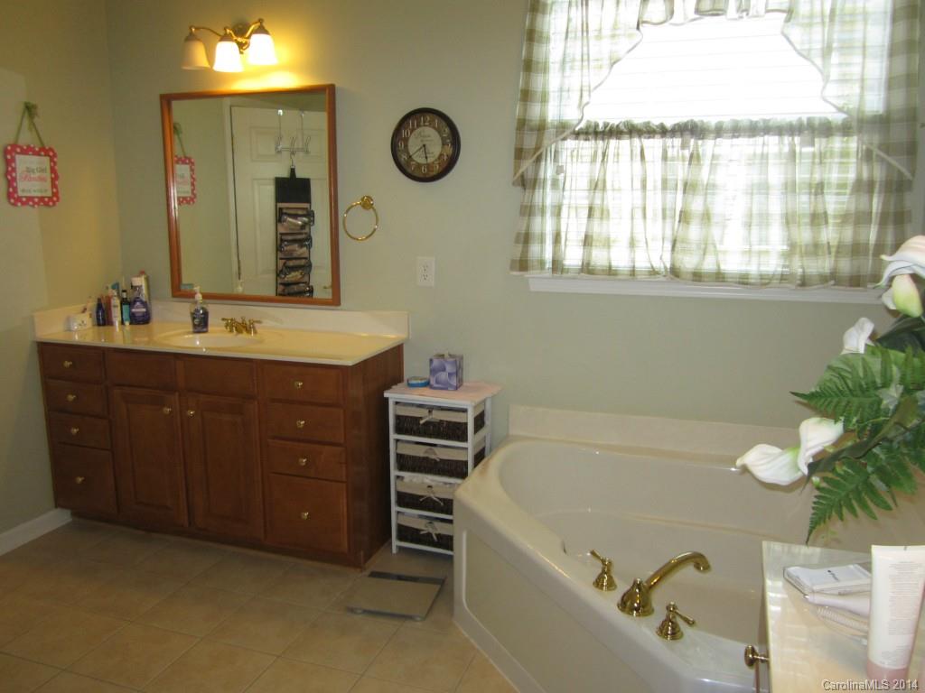 547 Turquoise Way Fort Mill, SC 29708 - Photo 8 of 12 a bathroom with a tub sink and mirror