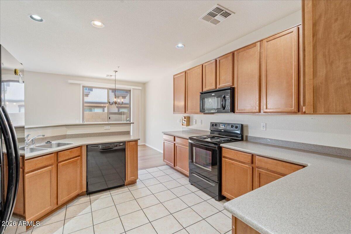 1255 South Rialto, Unit 106 Mesa, AZ 85209 - Photo 13 of 32 a kitchen with stainless steel appliances granite countertop a stove top oven sink and cabinets