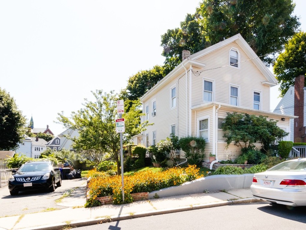11 Rugdale Road Boston, MA 02124 - Photo 3 of 29 a view of a white house with a yard and potted plants