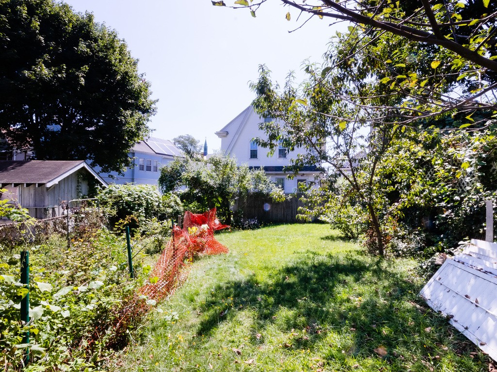 11 Rugdale Road Boston, MA 02124 - Photo 4 of 29 a view of a garden with a house in the background