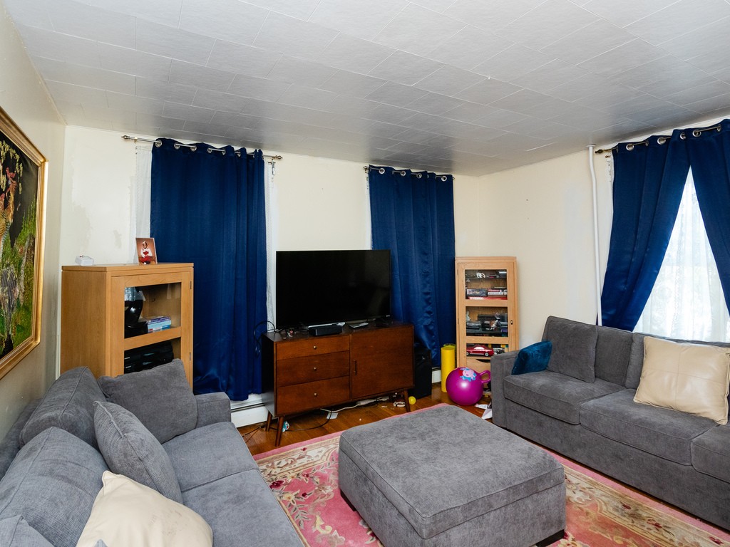 11 Rugdale Road Boston, MA 02124 - Photo 8 of 29 a living room with furniture and a flat screen tv