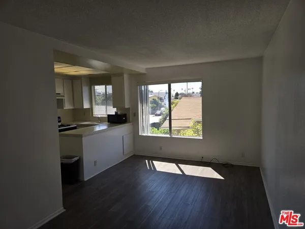 a kitchen with granite countertop a stove a sink and a window