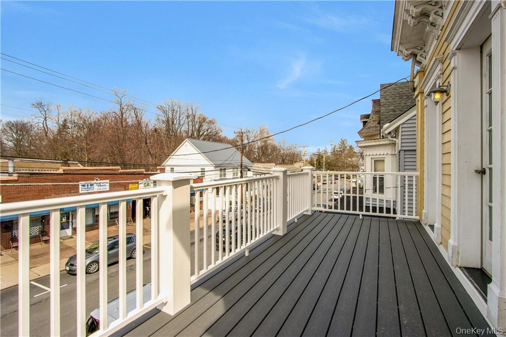 241 Main Street, Unit 2 Cornwall, NY 12518 - Photo 12 of 12 a view of a balcony with wooden floor and fence