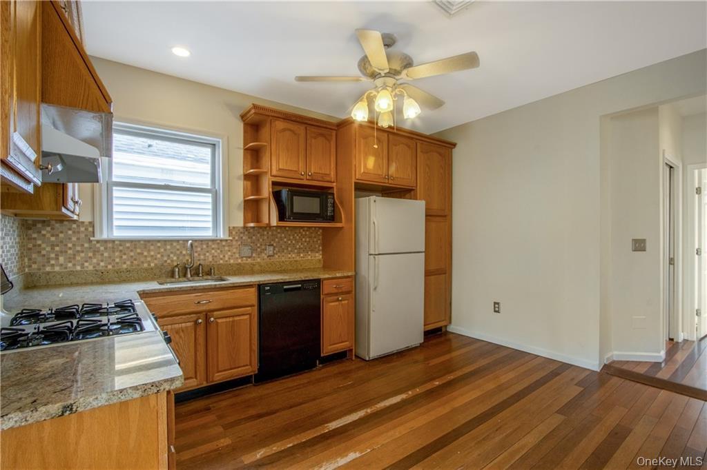 241 Main Street, Unit 2 Cornwall, NY 12518 - Photo 5 of 12 a kitchen with granite countertop a sink cabinets stainless steel appliances and a counter top space