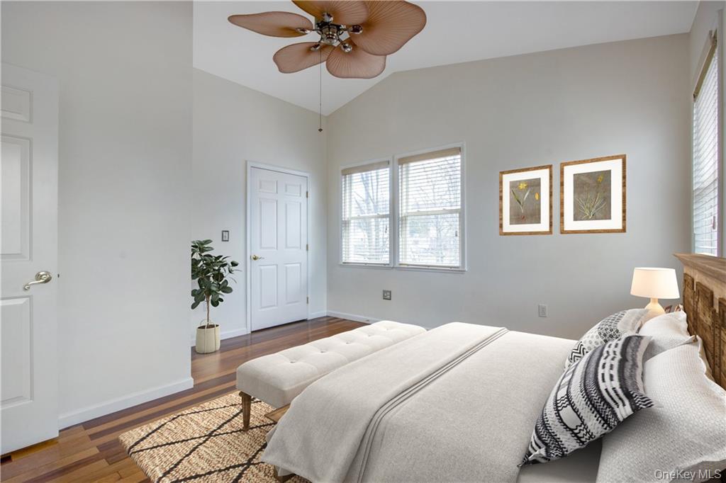 241 Main Street, Unit 2 Cornwall, NY 12518 - Photo 6 of 12 a bedroom with a bed and a chandelier