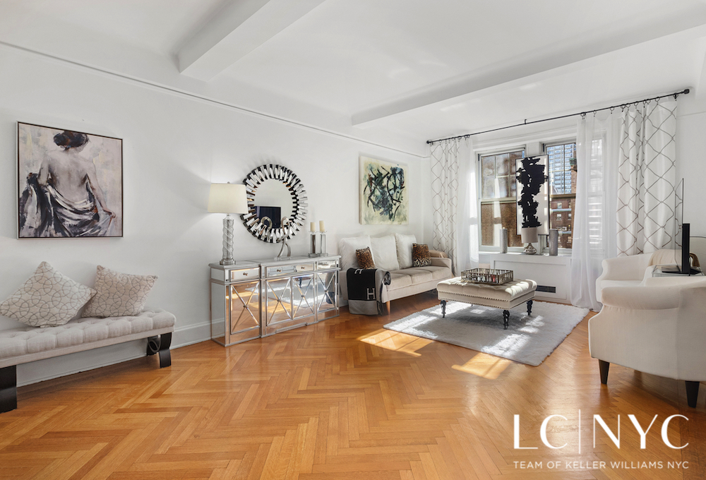a living room with furniture a rug and a window