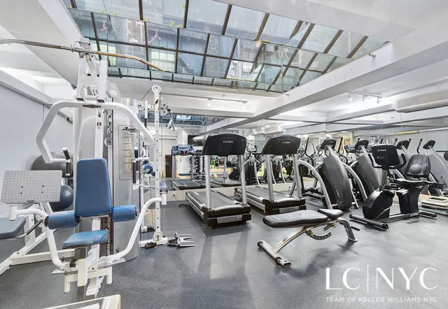 a view of a dining room with furniture a chandelier and wooden floor