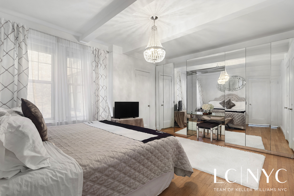 575 Park Avenue, Unit 1105 Manhattan, NY 10065 - Photo 6 of 18 a living room with furniture a dining table and a fireplace