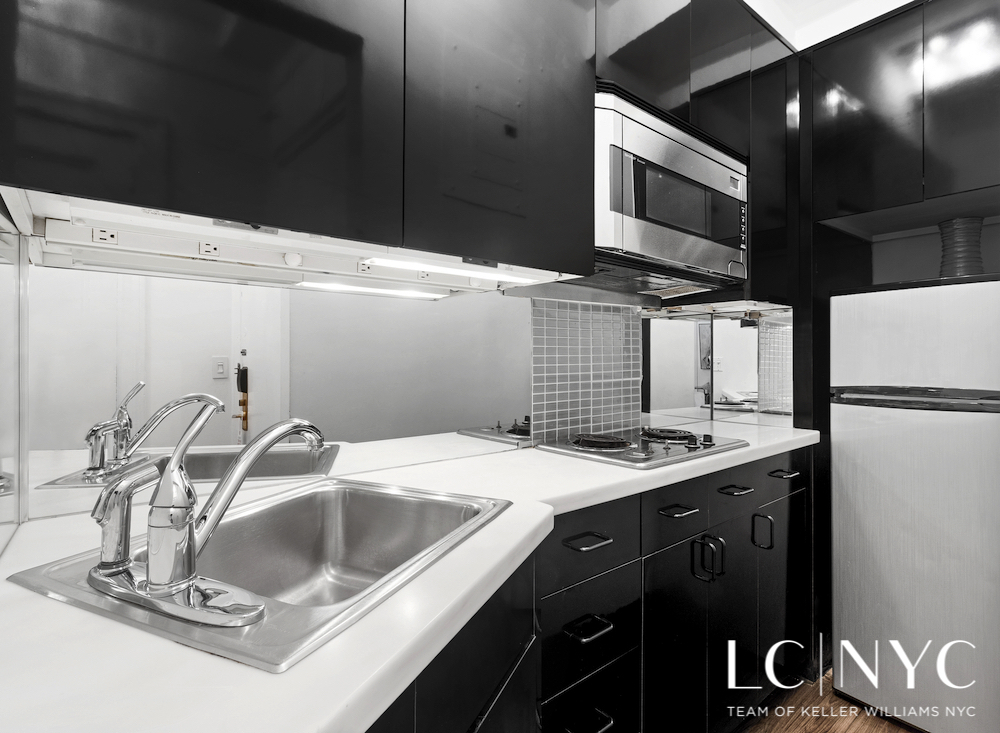 575 Park Avenue, Unit 1105 Manhattan, NY 10065 - Photo 9 of 18 a kitchen with a sink and a refrigerator