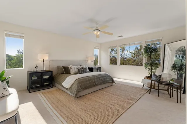 a spacious bedroom with a bed and a table