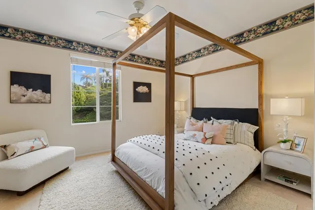 a bedroom with a bed couch and window