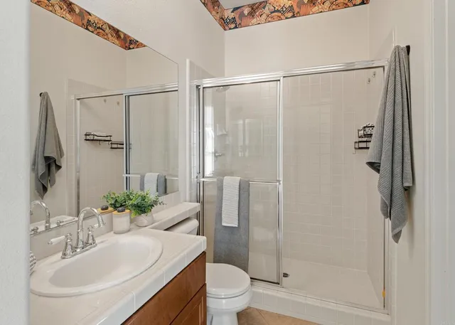 a bathroom with a sink toilet and shower