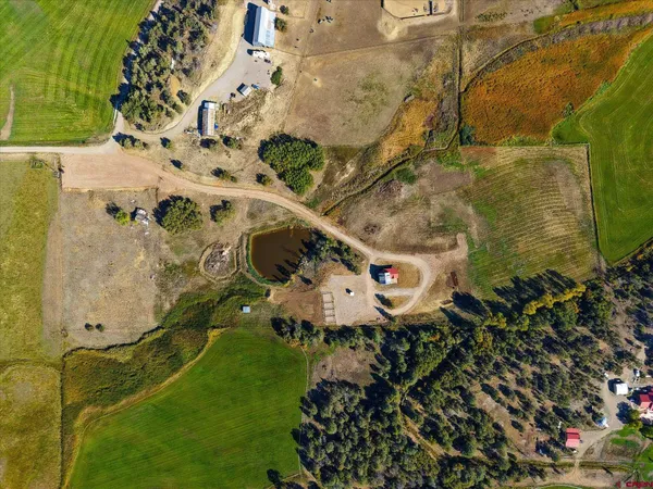 an aerial view of a house with a yard and garden