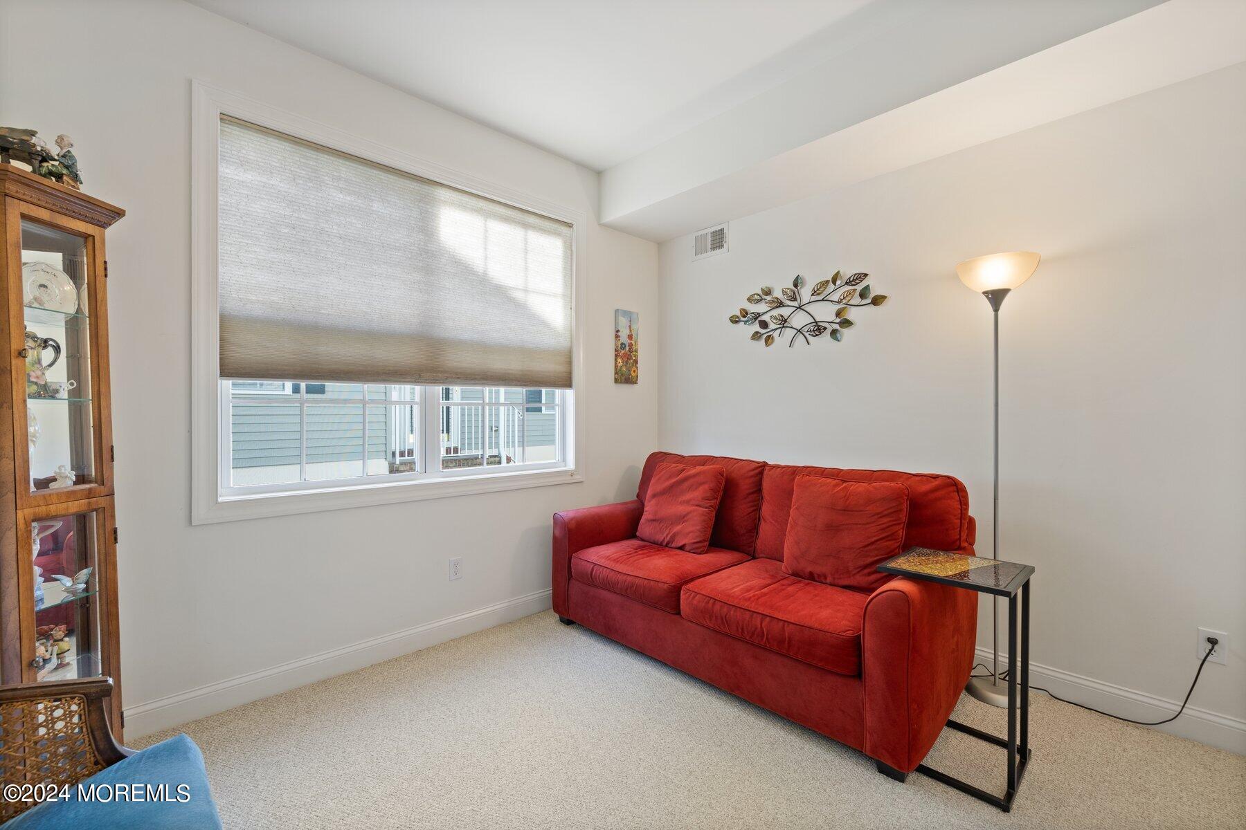 20 Silver Maple Lane Howell, NJ 07731 - Photo 22 of 35 a blue couch sitting in a living room next to a window