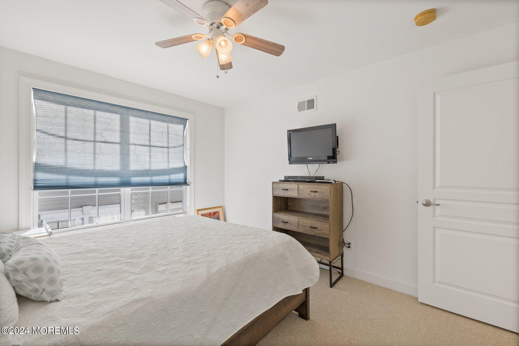 20 Silver Maple Lane Howell, NJ 07731 - Photo 26 of 35 a bedroom with a bed and a flat tv screen on the dresser