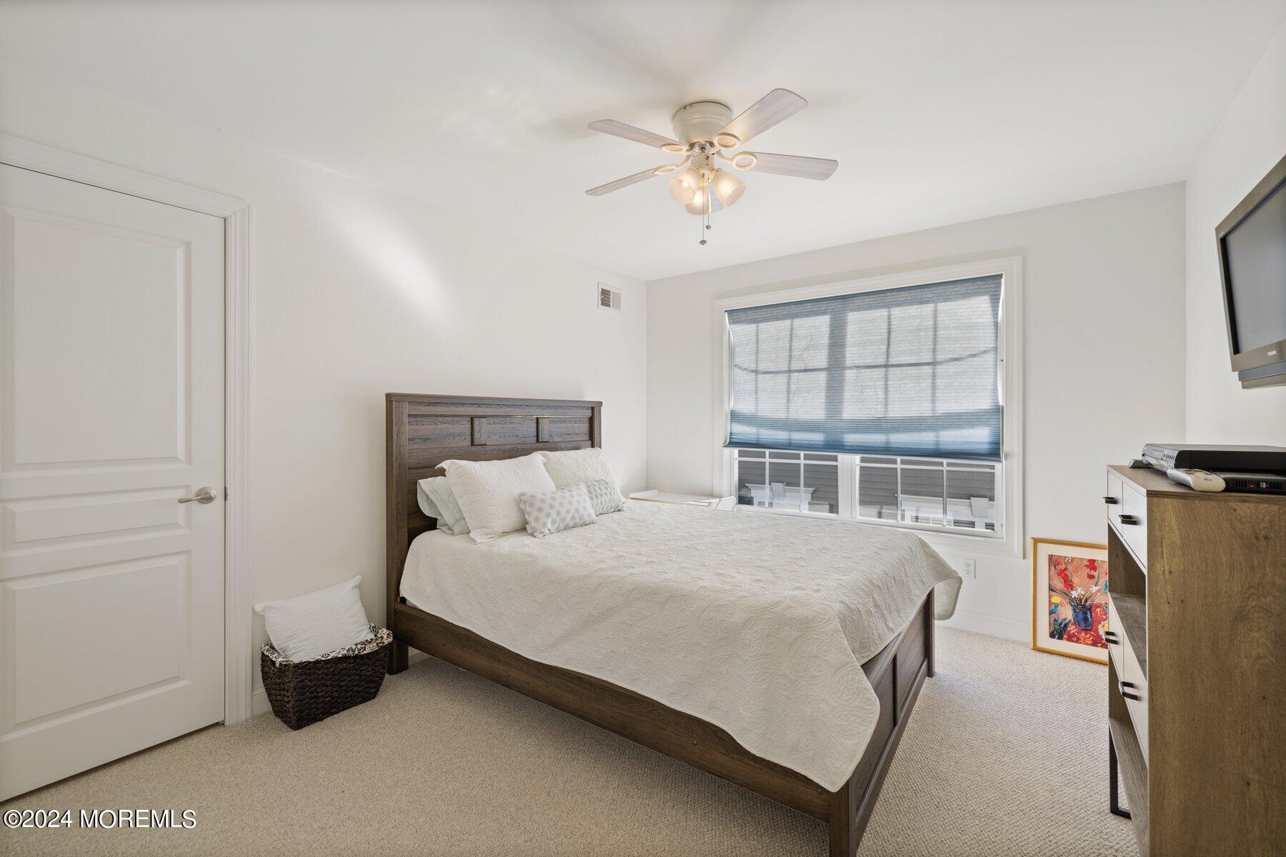 20 Silver Maple Lane Howell, NJ 07731 - Photo 27 of 35 a bedroom with a bed and a chandelier